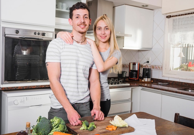 Portrait of young couple standing in the kitchen