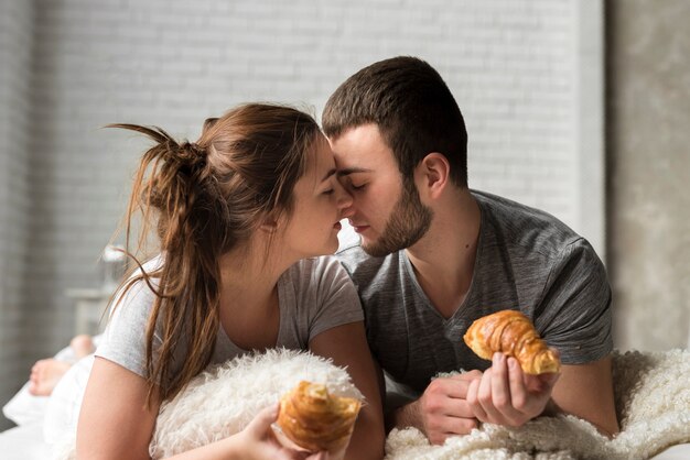 Portrait of young couple together in bed