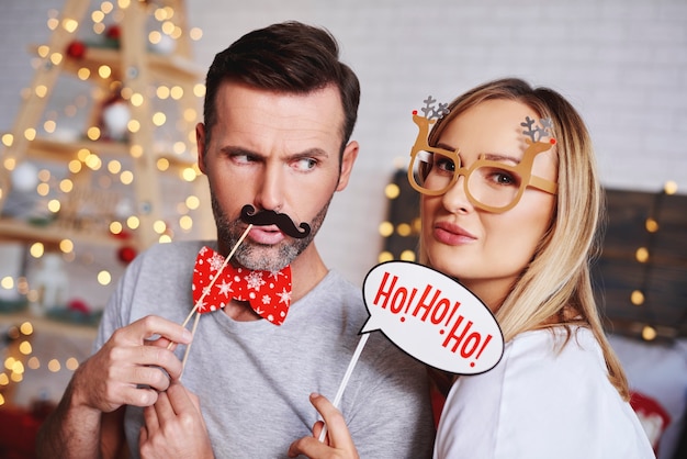 Free Photo portrait of young couple with christmas masks