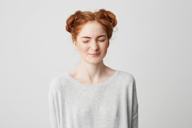 Portrait of young cute foxy girl laughing with closed eyes .