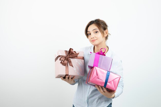 Portrait of a young cute girl holding present box with ribbon. High quality photo