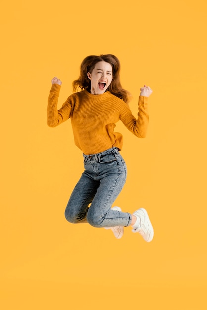 Portrait young female jumping