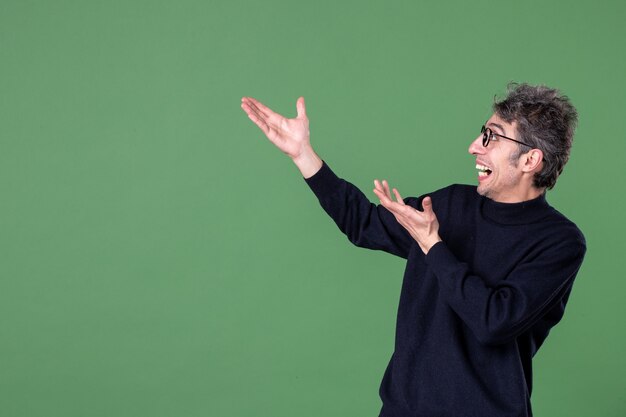 Portrait of young genius man dressed casually in studio shot on green wall