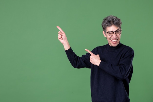 Portrait of young genius man dressed casually in studio shot on green wall