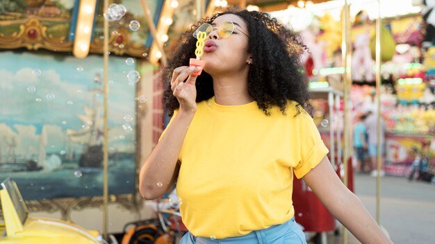 Portrait of young girl blowing bubbles