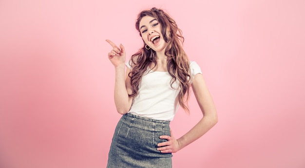 Free photo portrait of a young girl on a colored wall