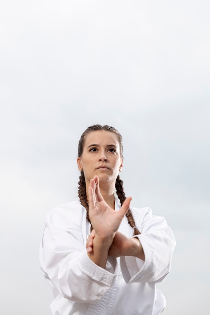 Free photo portrait of young girl in martial art costume