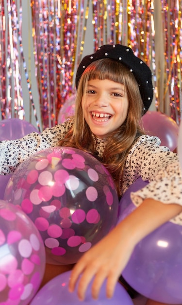 Portrait young girl at party with balloons