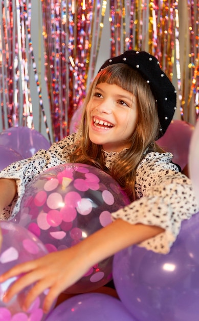 Portrait young girl at party with balloons