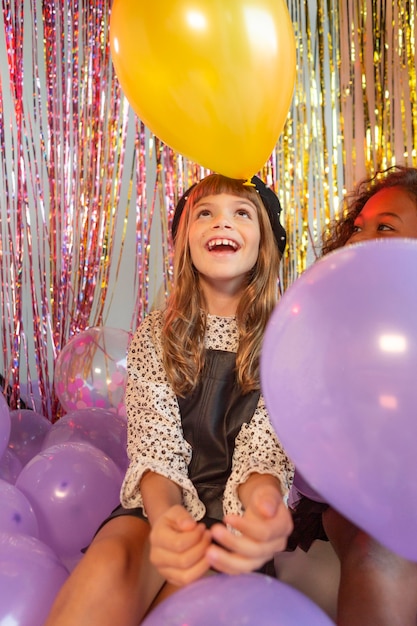 Portrait young girl at party with balloons