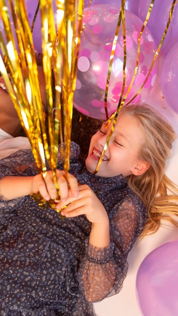 Free photo portrait young girl at party with balloons