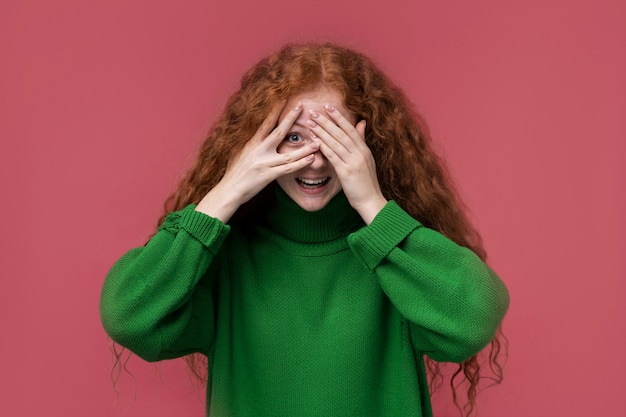 Portrait of young girl playing pick a boo