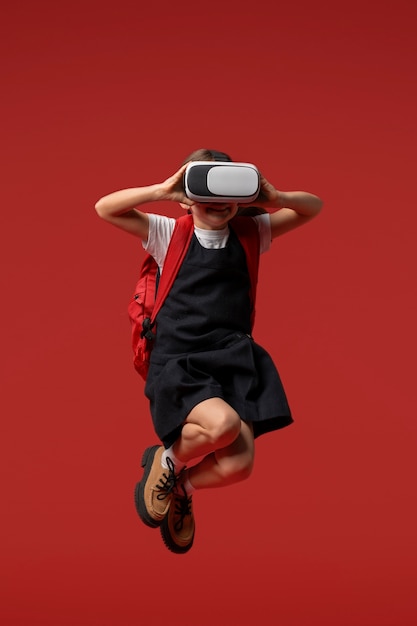 Free photo portrait of young girl student in school uniform and vr glasses