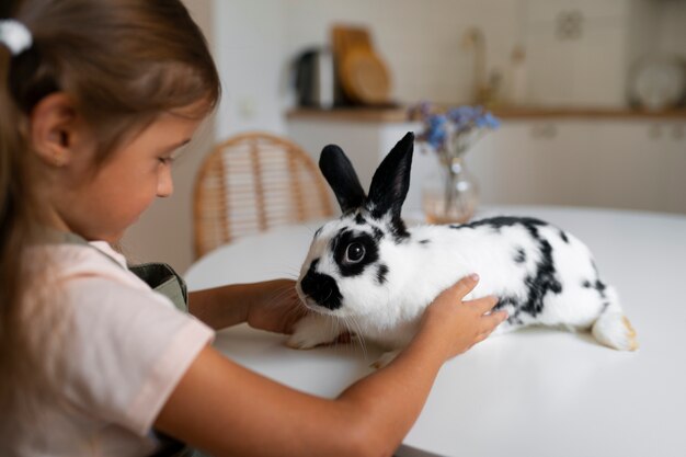 Free Photo portrait of young girl with her pet rabbit