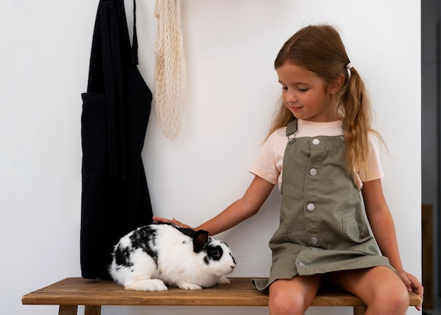 Free Photo portrait of young girl with her pet rabbit