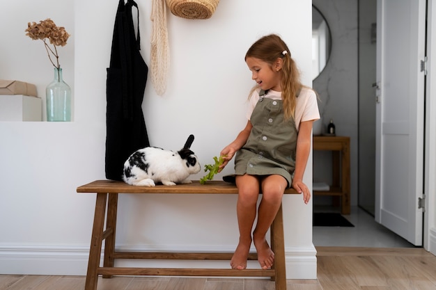 Free Photo portrait of young girl with her pet rabbit