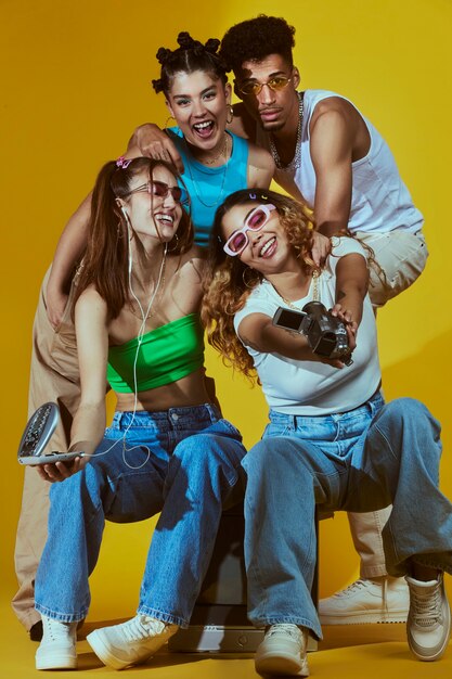 Portrait of young group of friends in 2000s fashion style posing with camera