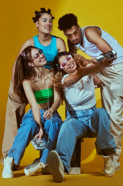 Portrait of young group of friends in 2000s fashion style posing with camera