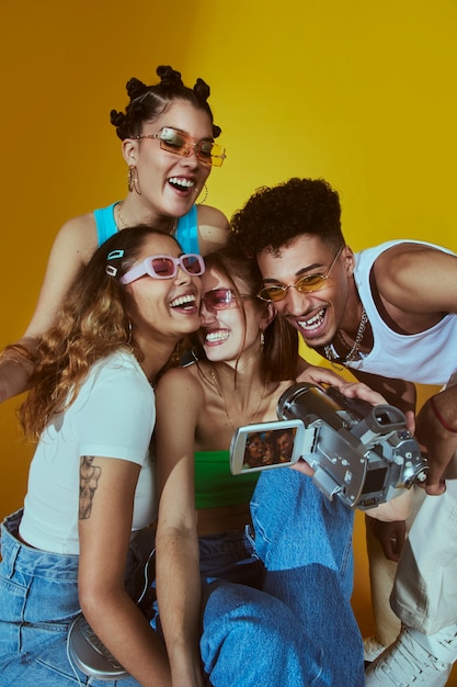 Portrait of young group of friends in 2000s fashion style posing with camera