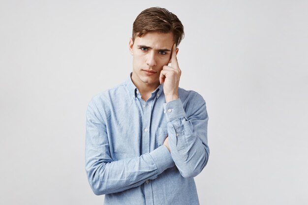 Portrait of young guy who tries concentrate.