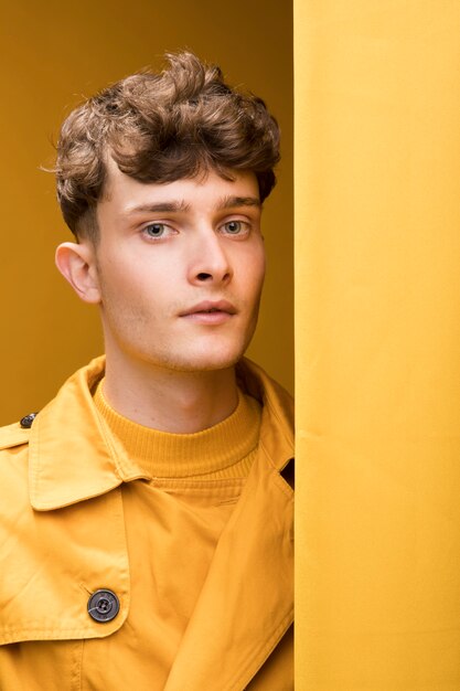 Portrait of young handsome man in a yellow scene