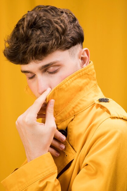 Portrait of young handsome man in a yellow scene