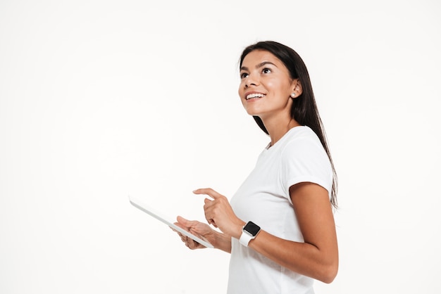 Portrait of a young happy woman holding tablet computer