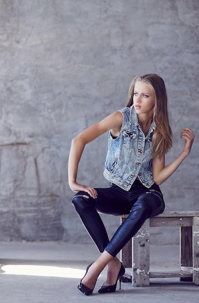 Portrait of young lady in jeans jacket.