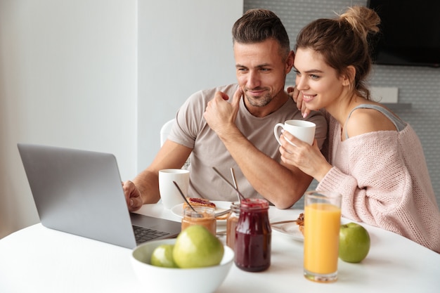 Portrait of a young loving couple having breakfast