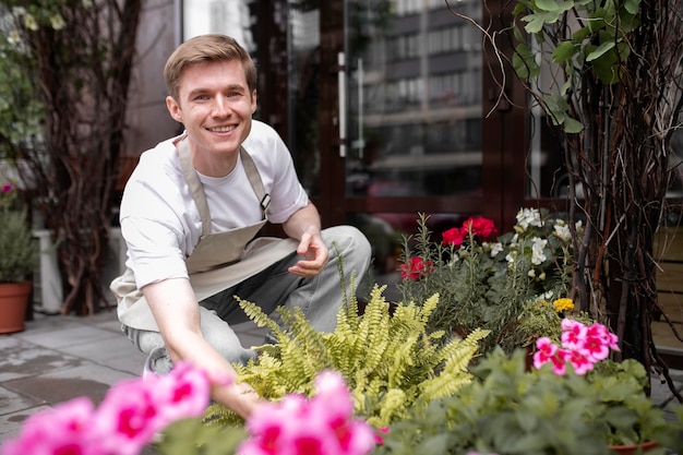 Free photo portrait of young male florist at work