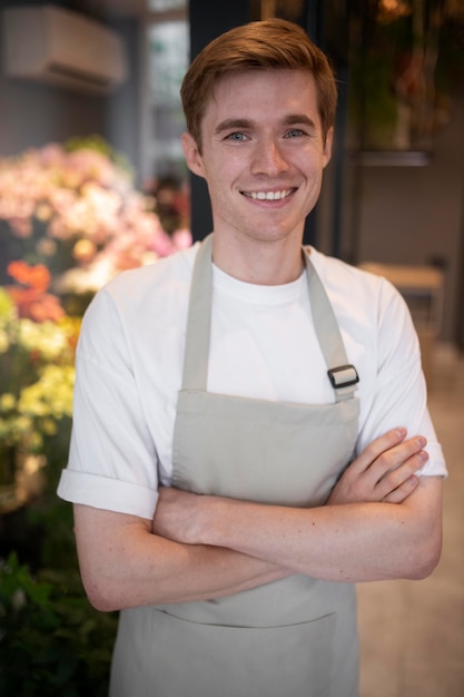 Free photo portrait of young male florist at work