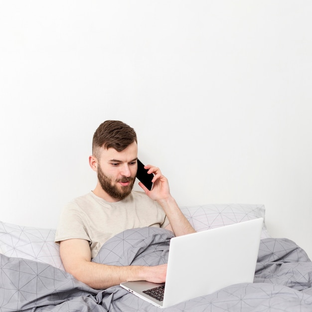 Free photo portrait of young male happy to work from home