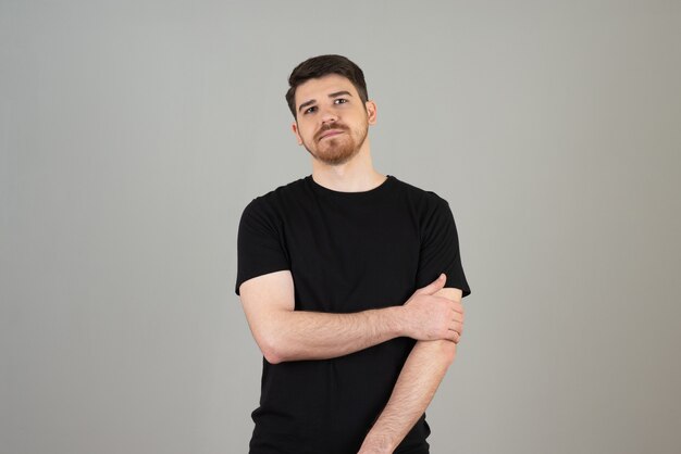 Portrait of young man on a grey.