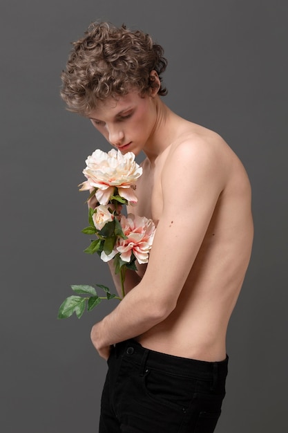 Portrait young man holding flowers