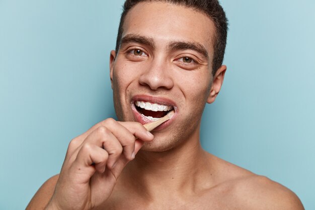 Portrait of young man holding toothbrush