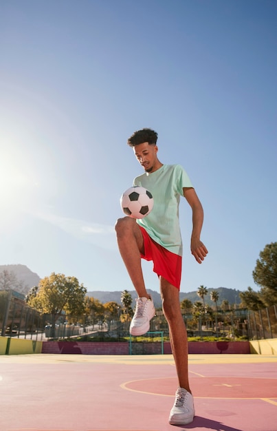 Portrait young man playing football