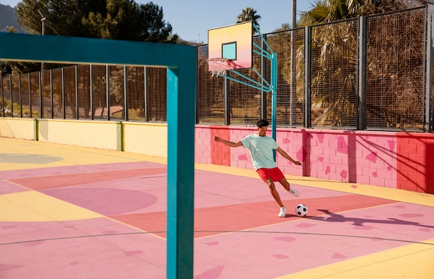 Portrait young man playing football