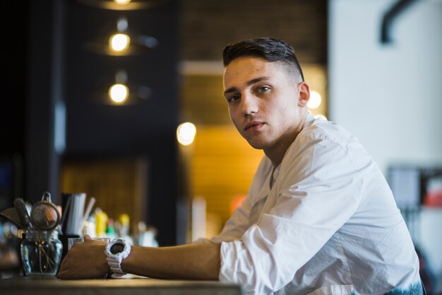 Portrait of a young man at restaurant