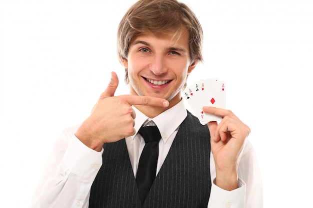 portrait of young man showing poker cards