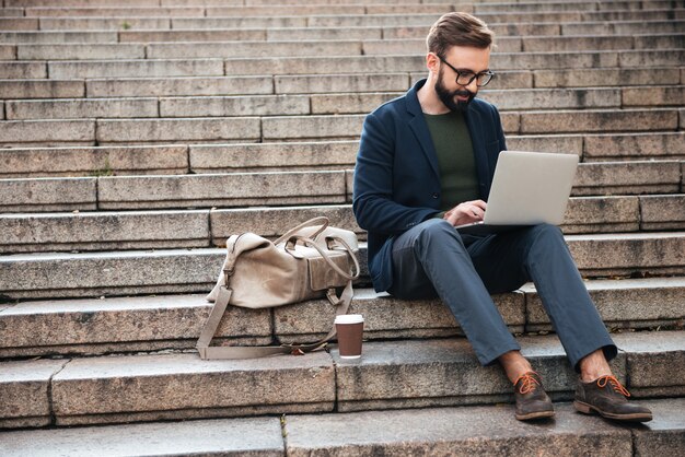 Portrait of young man using laptop computer