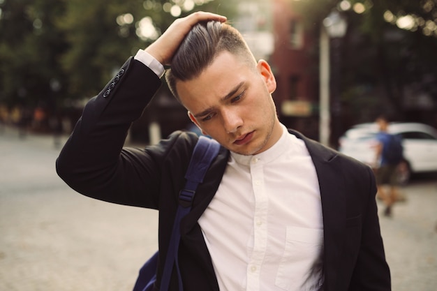 Portrait of young man with a backpack on his back