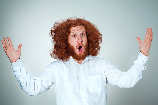 Free photo portrait of young man with shocked facial expression