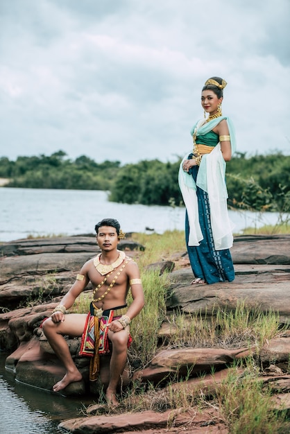 Portrait of Young man and woman wearing beautiful traditional costume pose in nature in Thailand