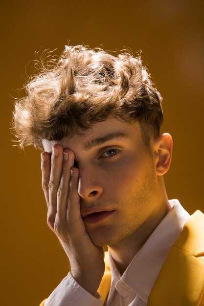 Portrait of a young man in a yellow scene