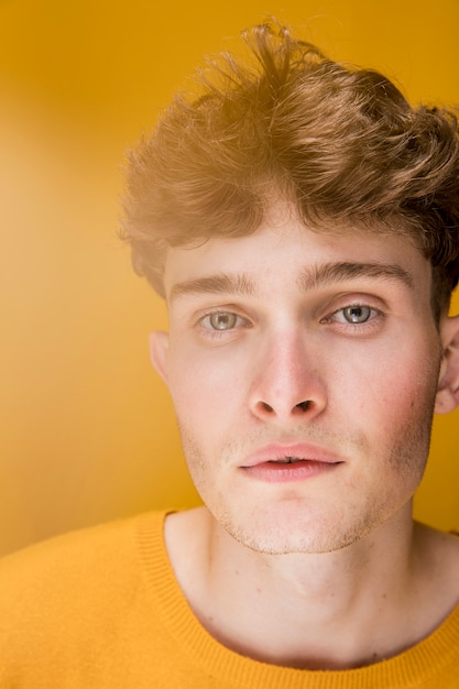 Free Photo portrait of a young man in a yellow scene