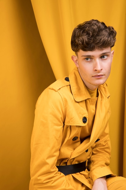 Free Photo portrait of a young man in a yellow scene