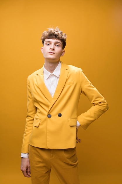 Free Photo portrait of a young man in a yellow scene