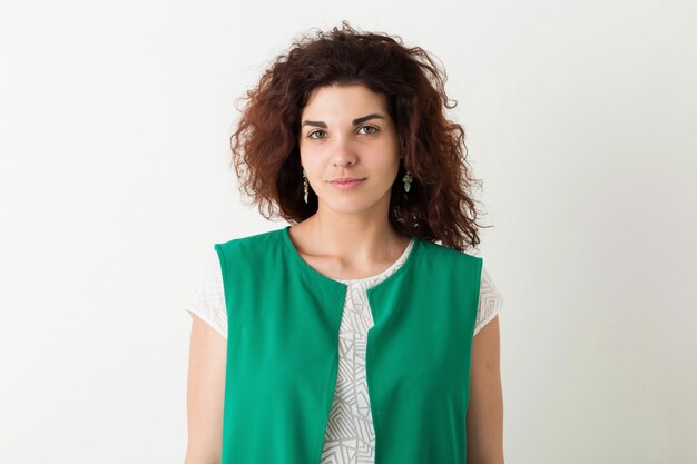 Portrait of young natural pretty woman with curly hairstyle in green shirt posing isolated