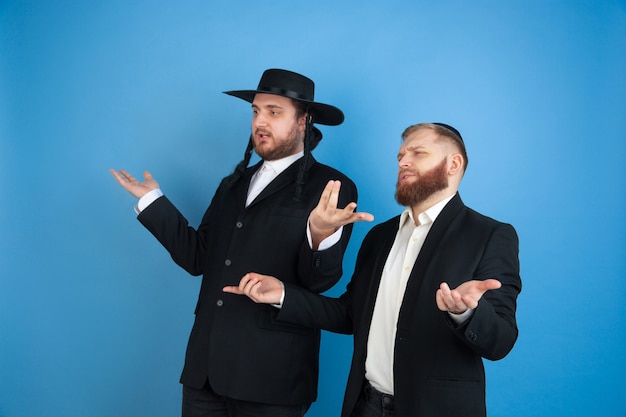 Portrait of a young orthodox jewish men isolated on blue studio