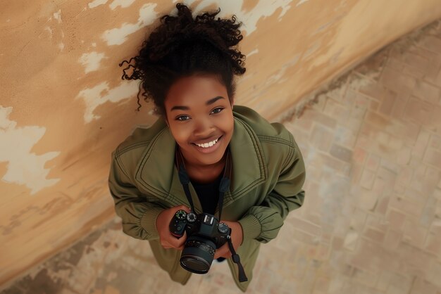 Portrait of young person holding camera device for world photography day